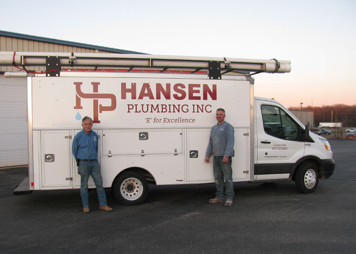 employees standing in front of hansen plumbing work truck